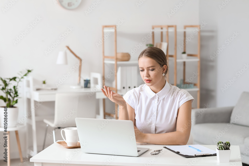 Psychologist working with patient online while sitting in office