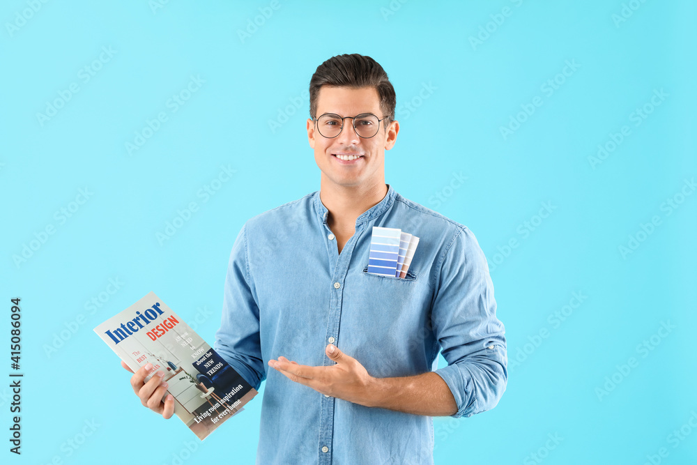 Male interior designer on color background