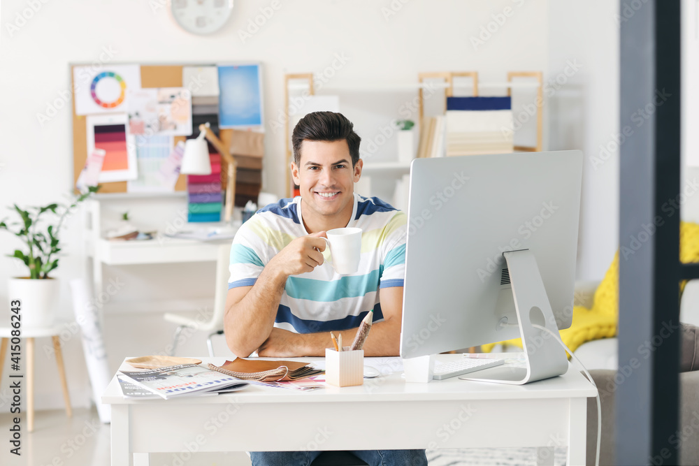 Male interior designer working in his office