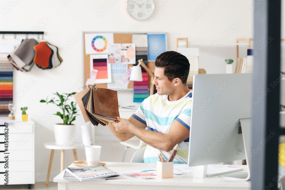 Male interior designer working in his office