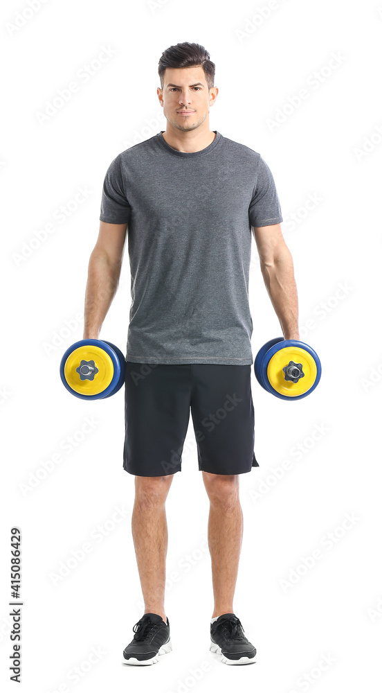 Sporty young man training with dumbbells on white background