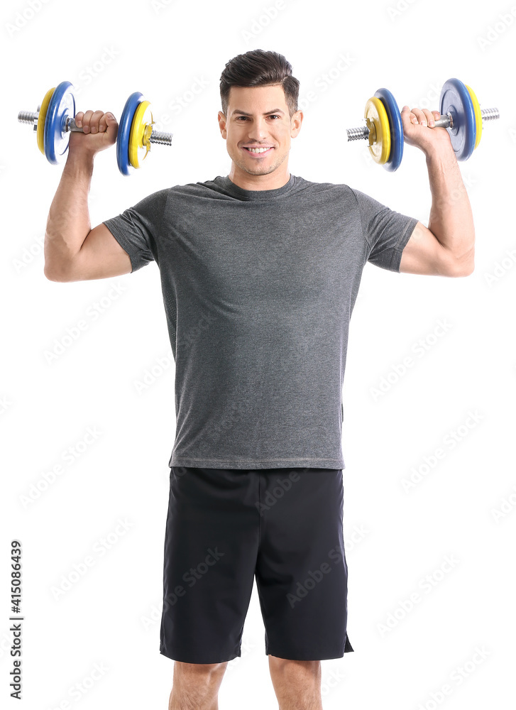 Sporty young man training with dumbbells on white background