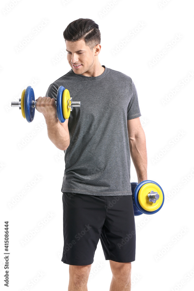 Sporty young man training with dumbbells on white background