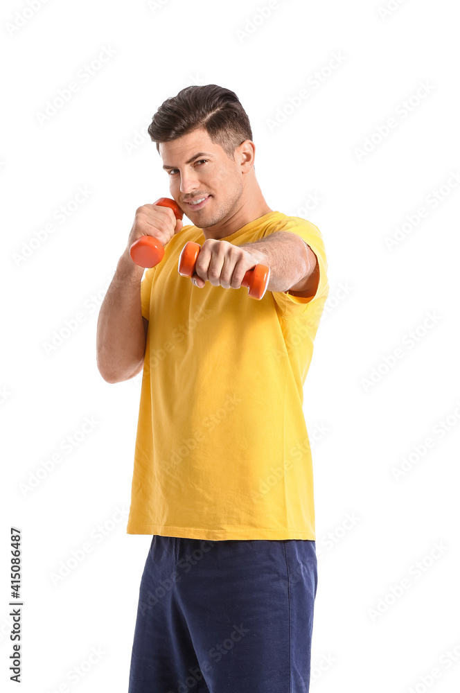 Sporty young man training with dumbbells on white background