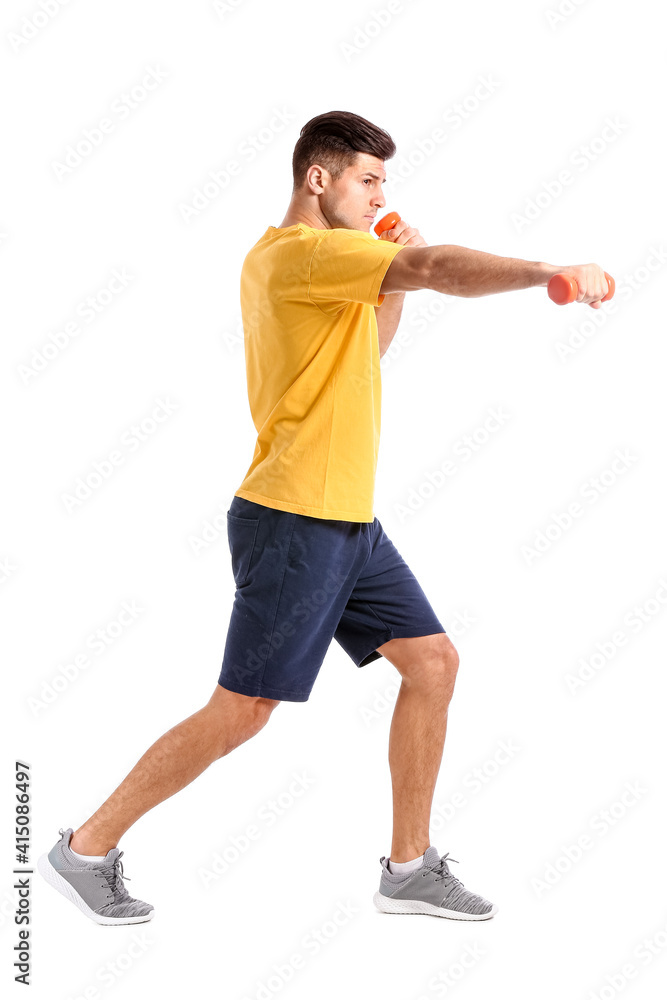 Sporty young man training with dumbbells on white background