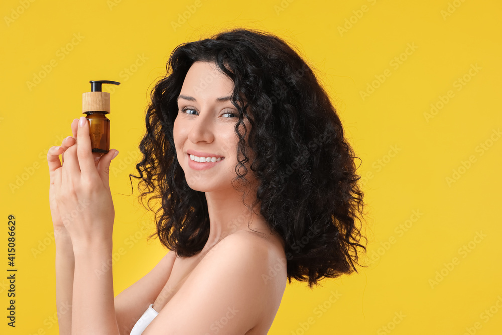 Beautiful young woman with cosmetic product on color background