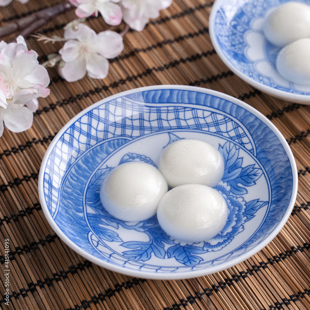 Close up of yuanxiao tangyuan in a bowl on gray table, food for Chinese Lantern Yuanxiao Festival.