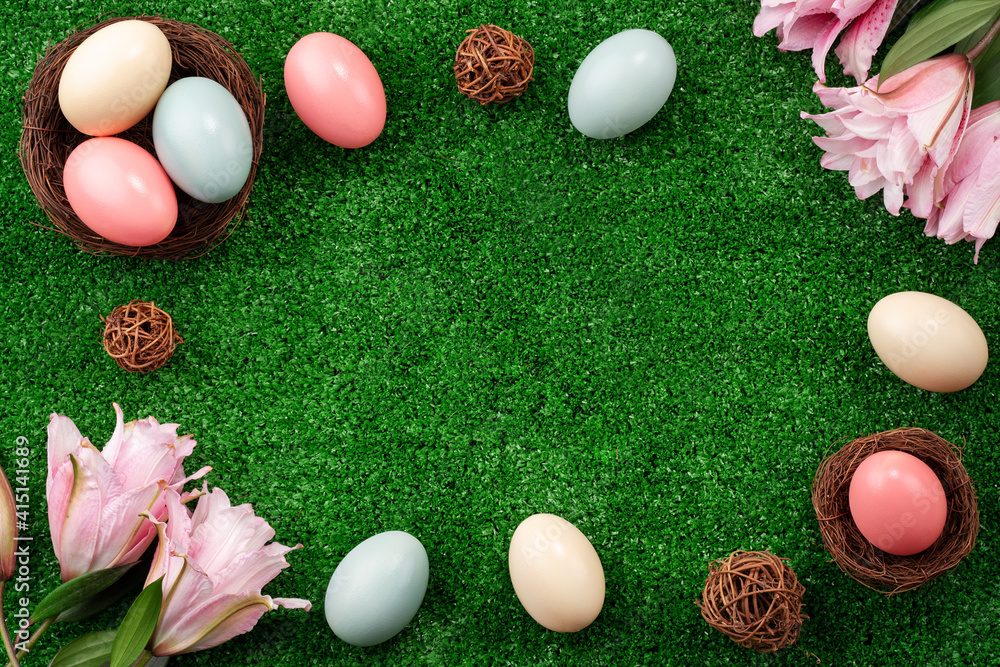 Colorful Easter eggs in the nest on a lawn with pink Double Lily flower.