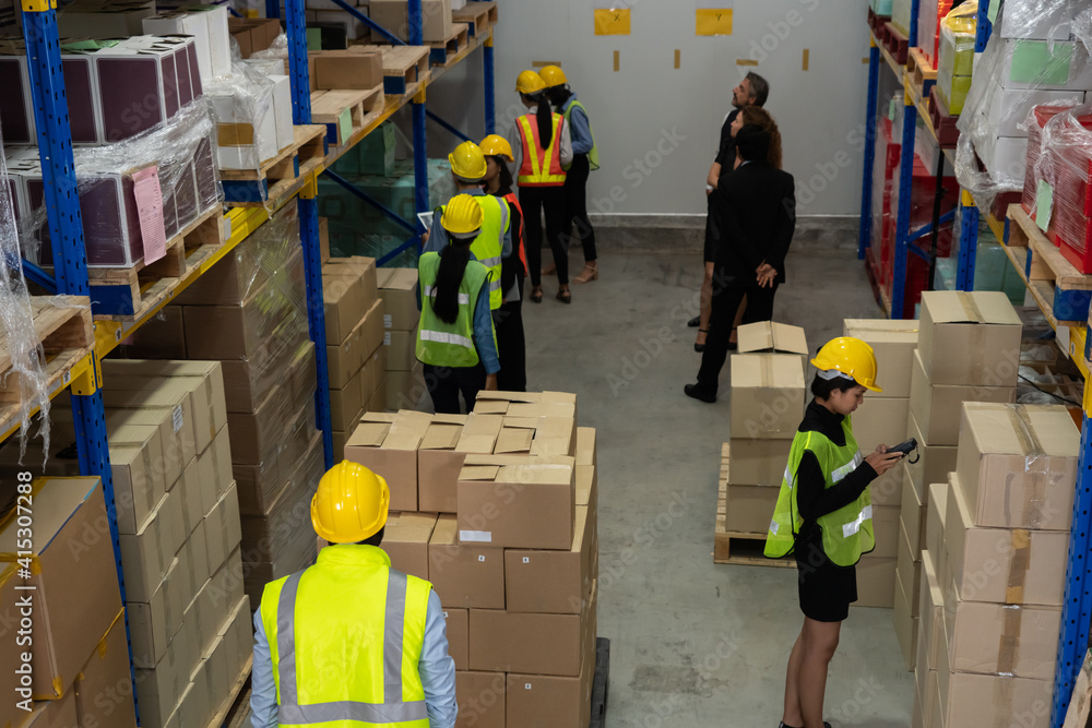 Many people , workers and manger work in warehouse or storehouse . Logistics , supply chain and ware