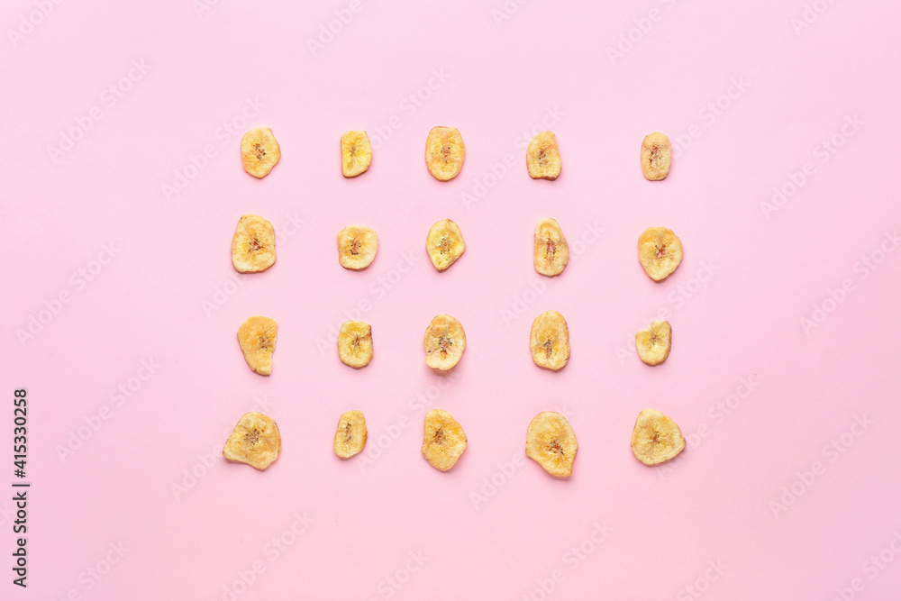 Crispy banana chips on color background