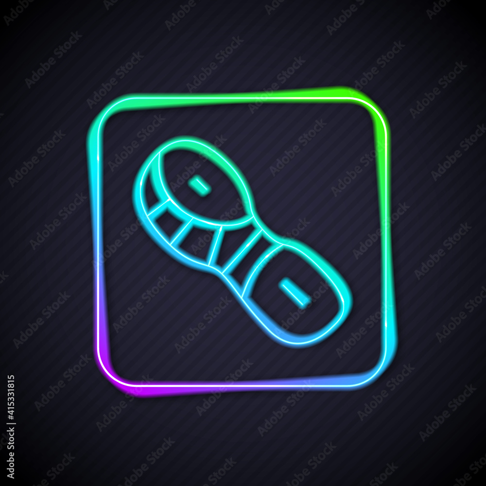 Glowing neon line Human footprints shoes icon isolated on black background. Shoes sole. Vector.