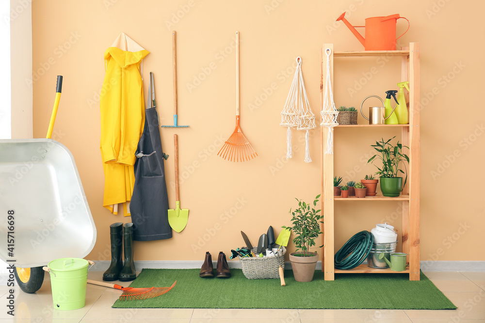 Set of gardening supplies and houseplants in barn