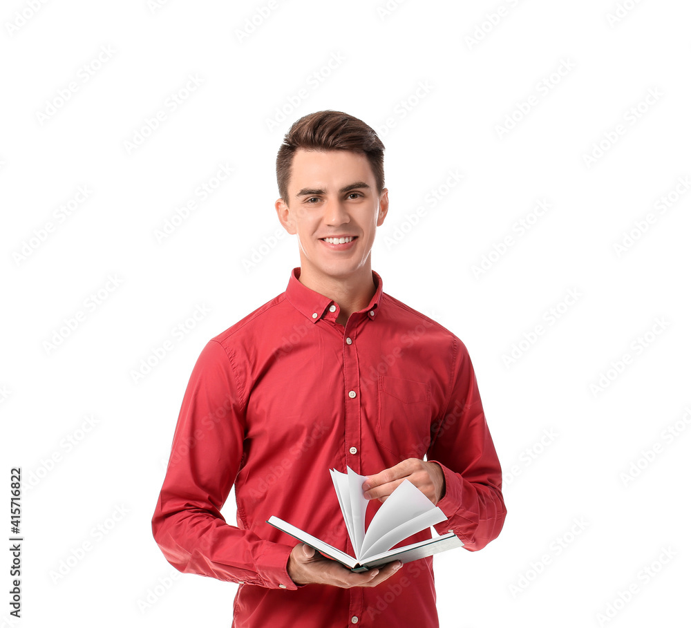 Young man with book on white background