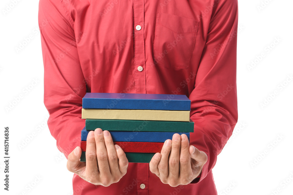 Young man with books on white background, closeup