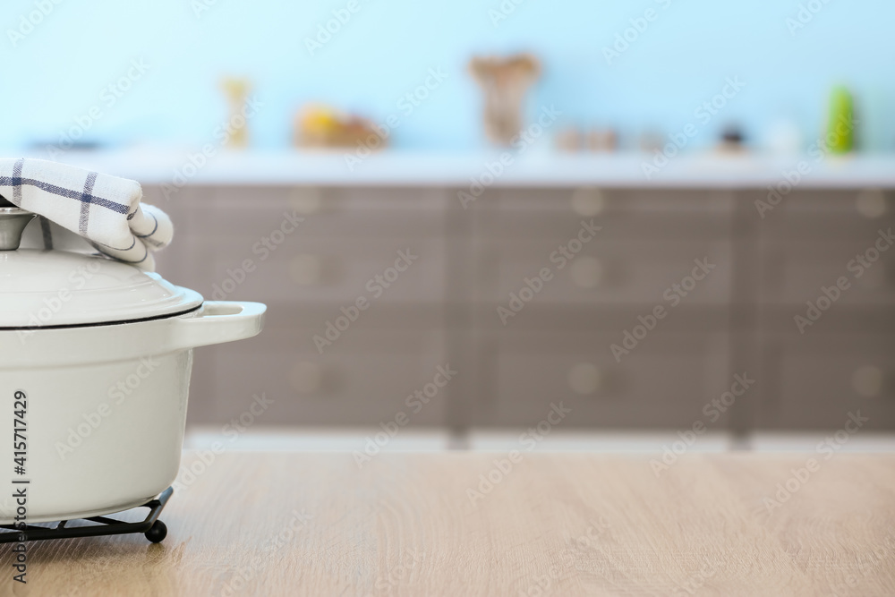 Cooking pot on table in modern kitchen