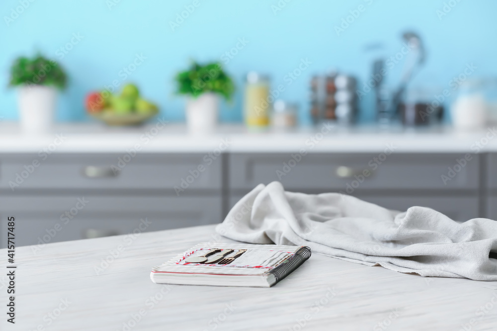 Recipe book on table in modern kitchen