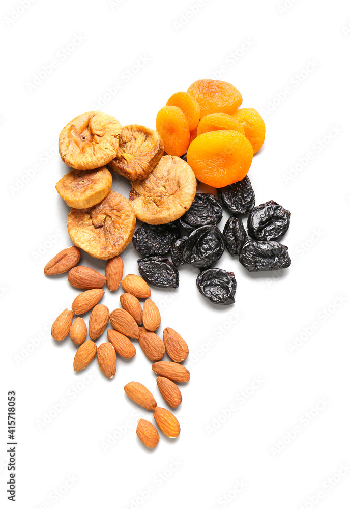 Different dried fruits and nuts on white background