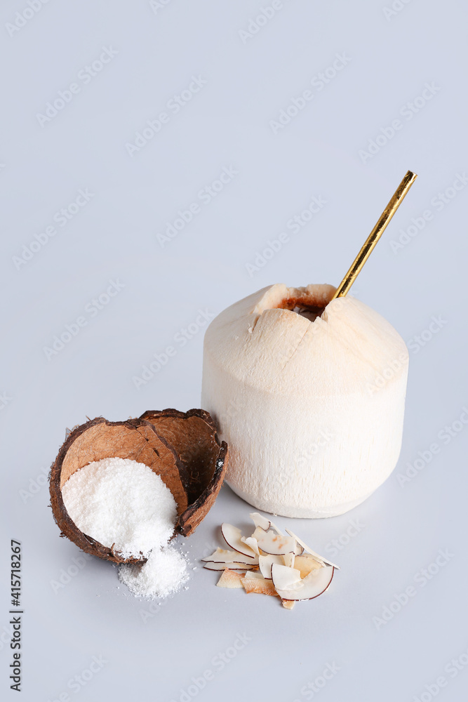 Fresh and ripe coconuts on light background