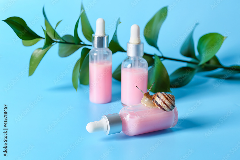 Cosmetics with mucin and snail on color background