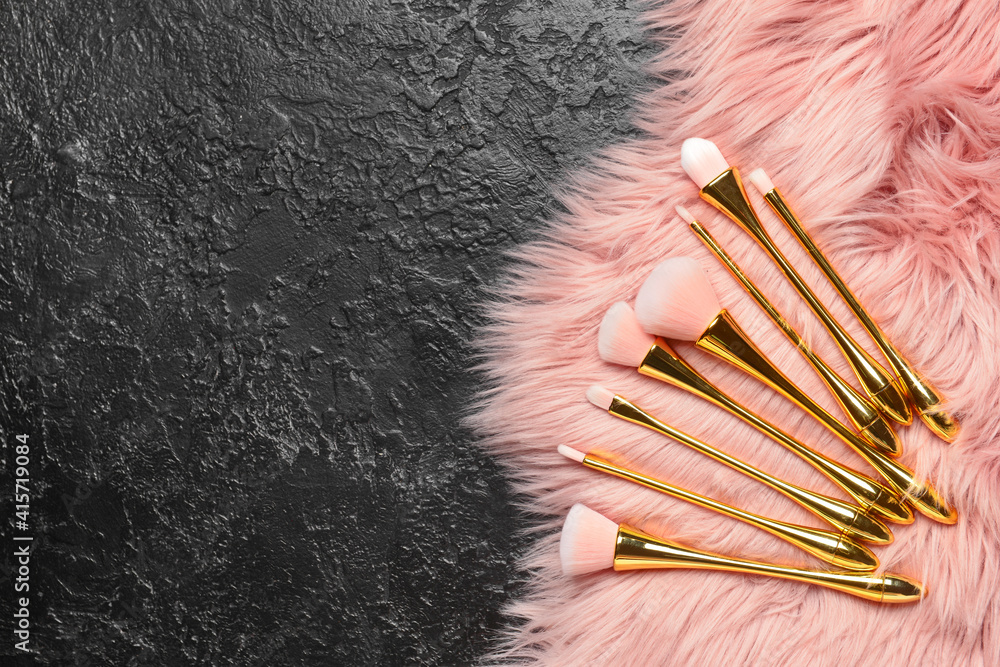 Set of makeup brushes on dark background