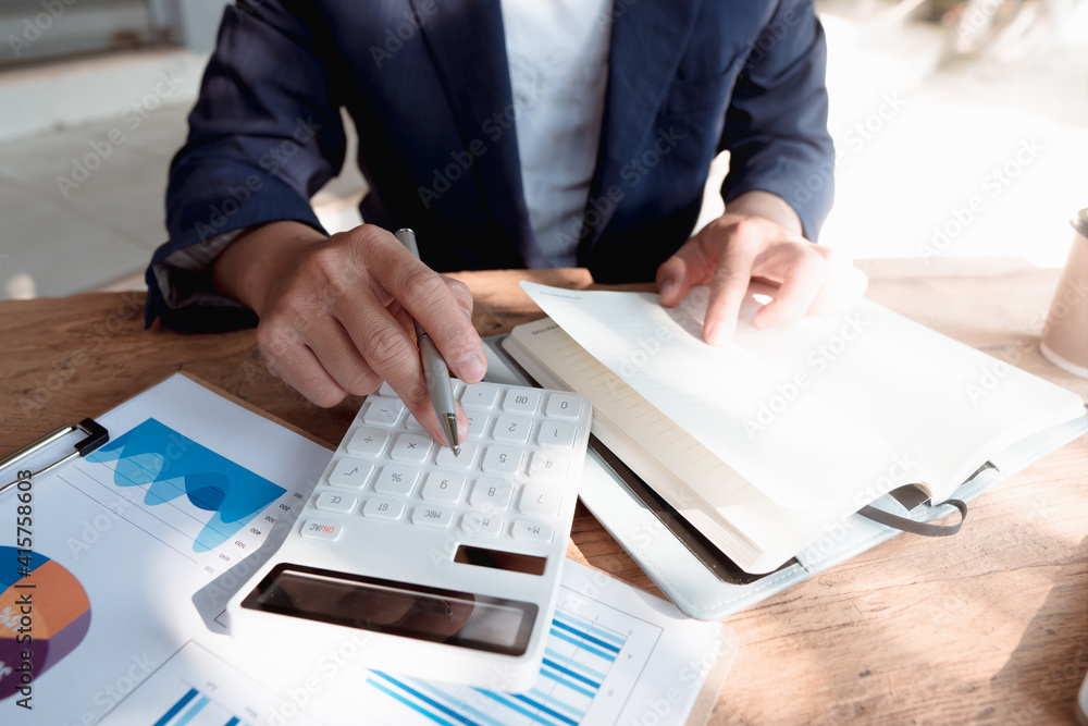 employee accountant man hand press on calculator for make financial report or companys profit month