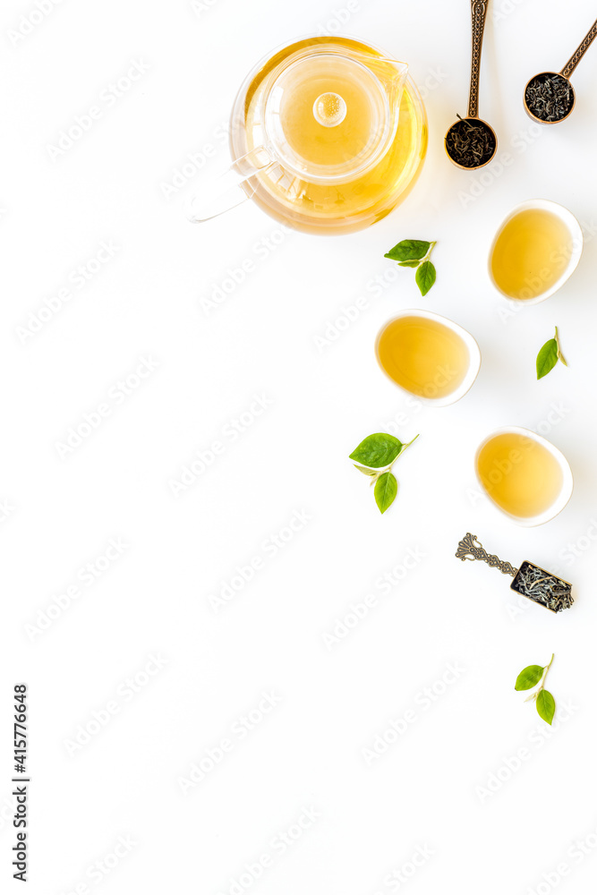 Tea ceremony concept. Hot and dry tea in teapot and cups, top view