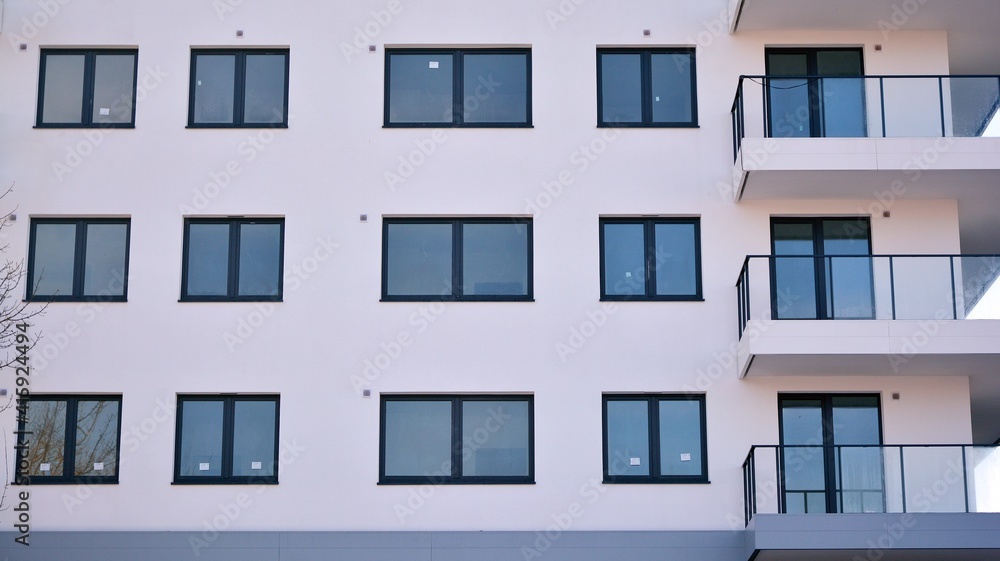 Condominium and apartment building with  symmetrical modern architecture in the city downtown.