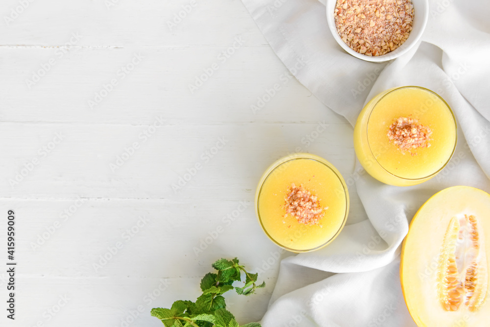 Glasses with melon smoothie on light background