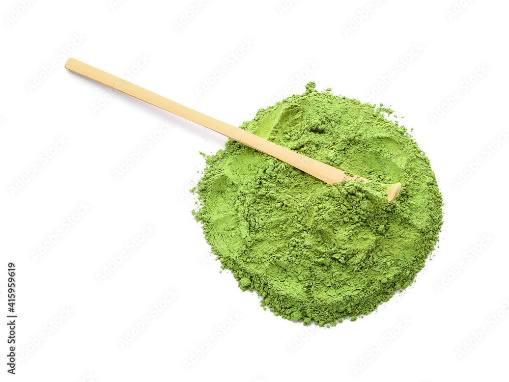 Powdered matcha tea and chashaku on white background