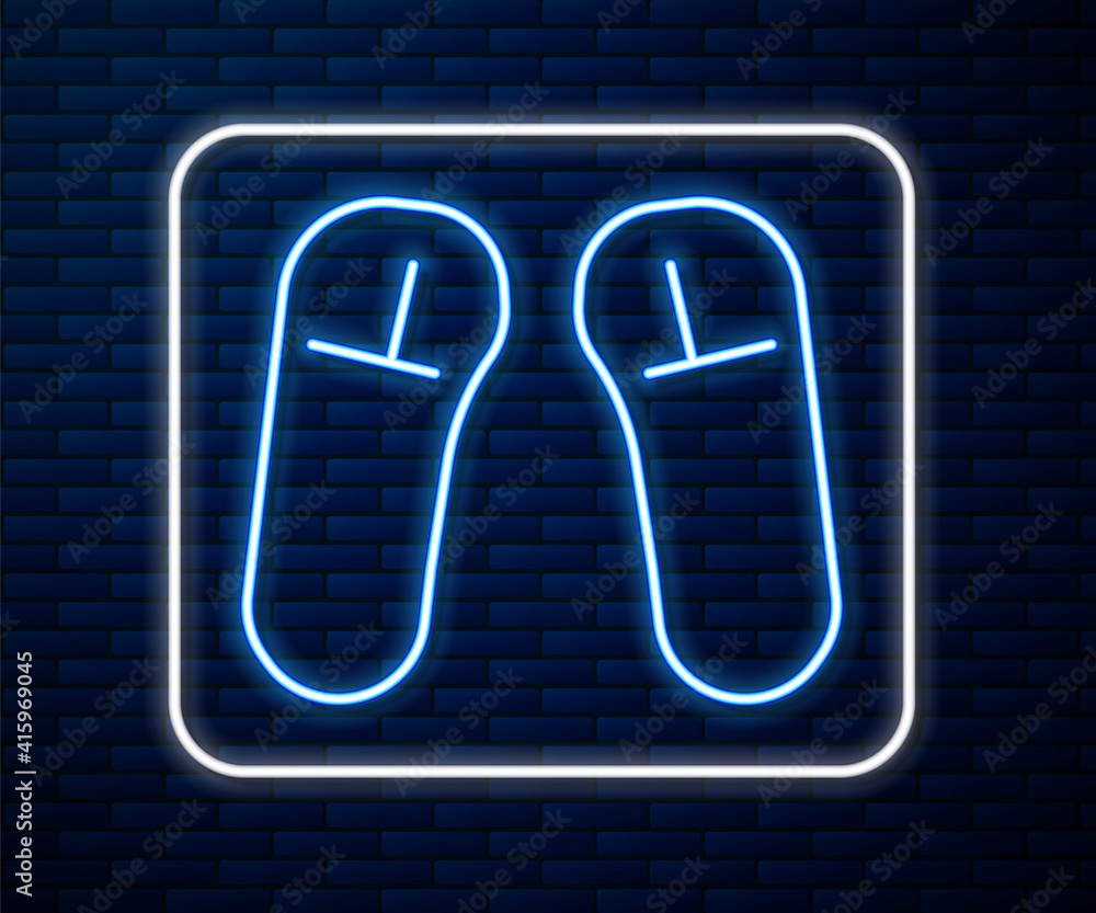 Glowing neon line Slipper icon isolated on brick wall background. Flip flops sign. Vector Illustrati