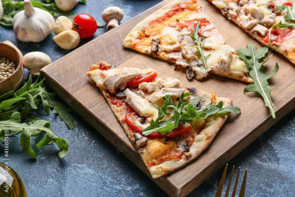 Board with slices of tasty pizza on color background