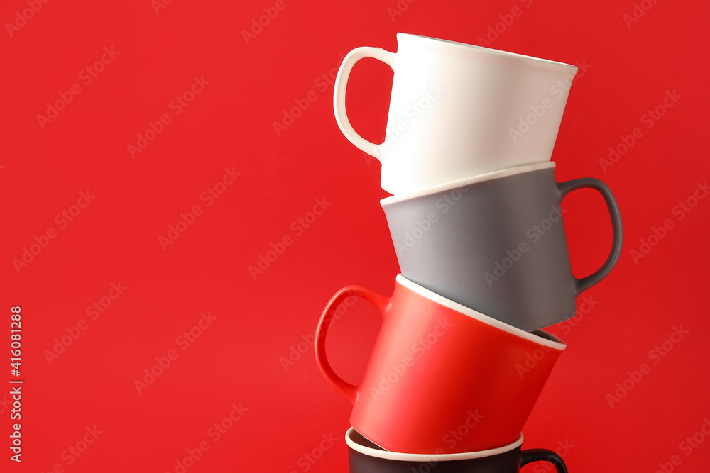 Empty cups on color background