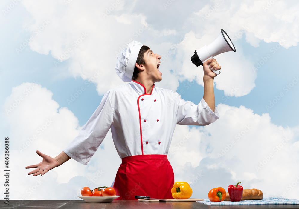 Young chef shouting loudly into megaphone