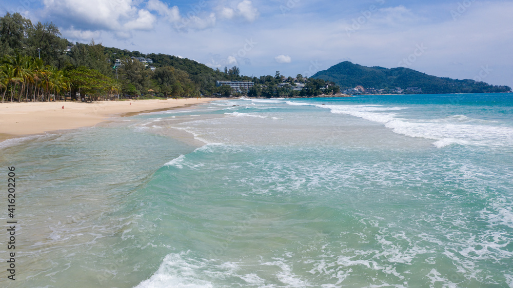 Aerial: Surin beach is a beautiful white-sand beach which is located at Phuket, Thailand