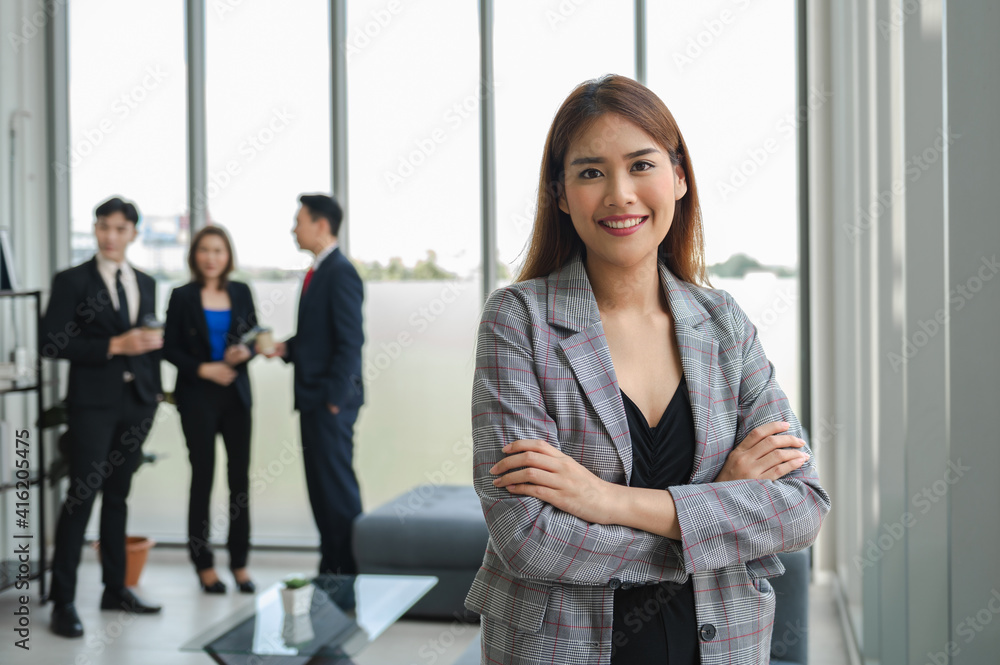 businesswoman standing arm cross and smile in office