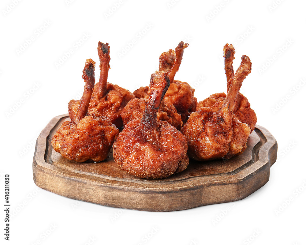 Board with tasty chicken lollipops on white background