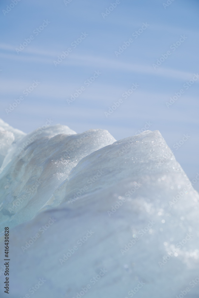 Ice pyramids on blue sky background.