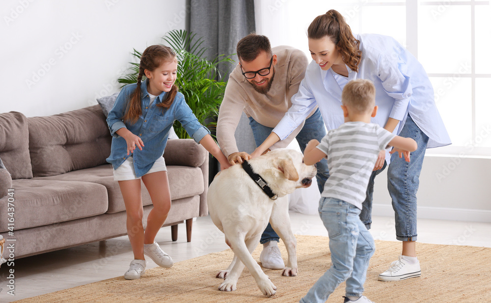 Parents and kids having fun with dog at home