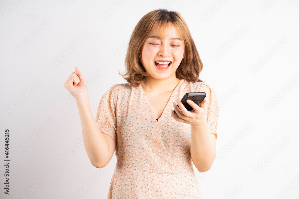 Young asian girl holding phone with expressions, gestures on background