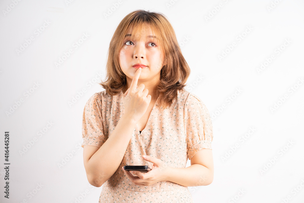 Young asian girl holding phone with expressions, gestures on background