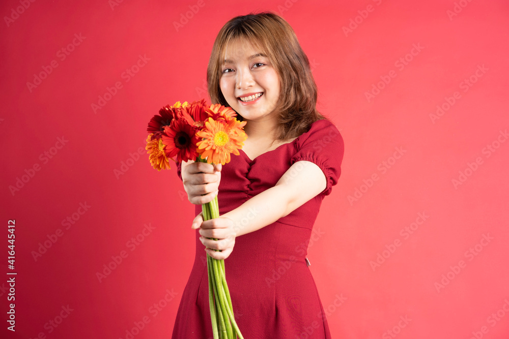 年轻女孩手持非洲菊花束，背景上表情欢快