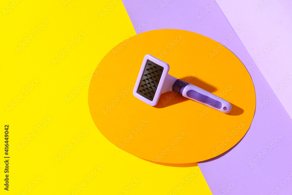 Grooming brush for pet on color background