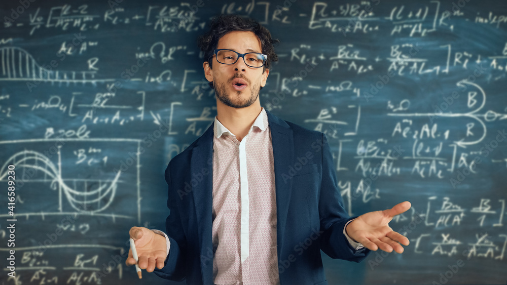 Online e-Education Concept: Teacher Explains Lesson to Classroom, Behind Him Blackboard with Writing