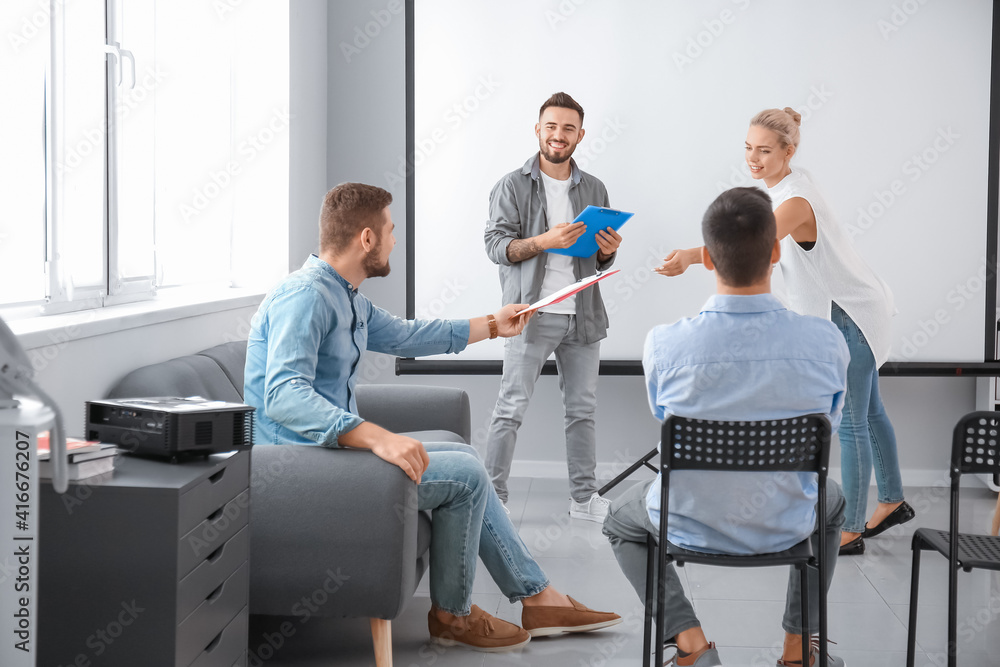 Business people giving presentation during meeting in office