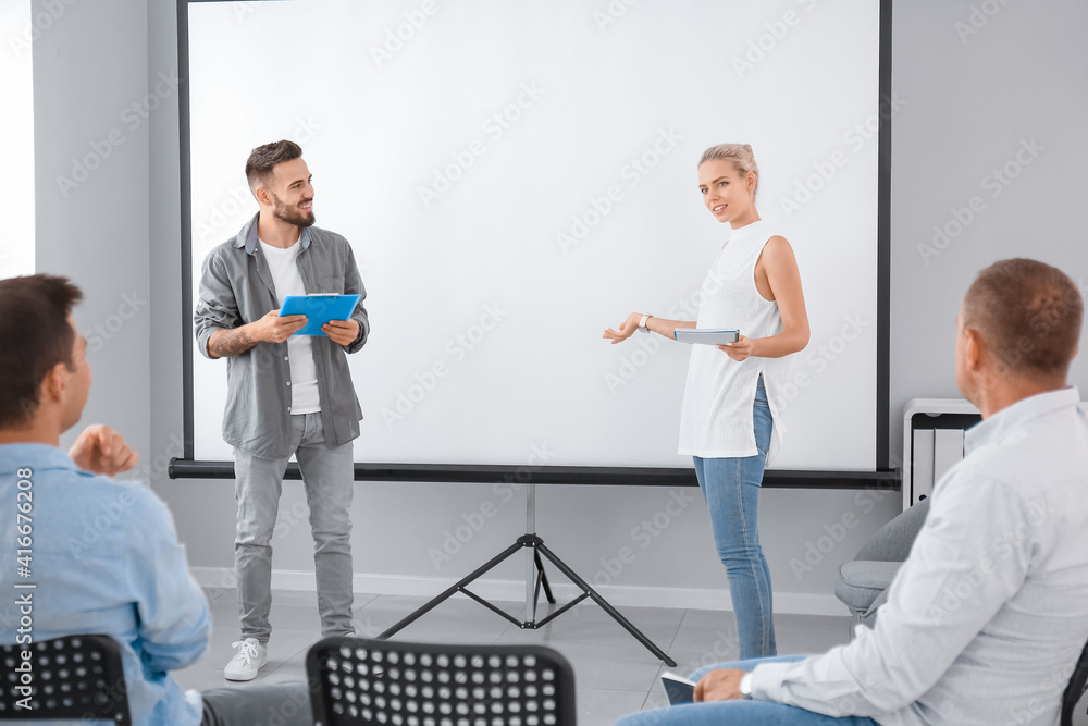 Business people giving presentation during meeting in office