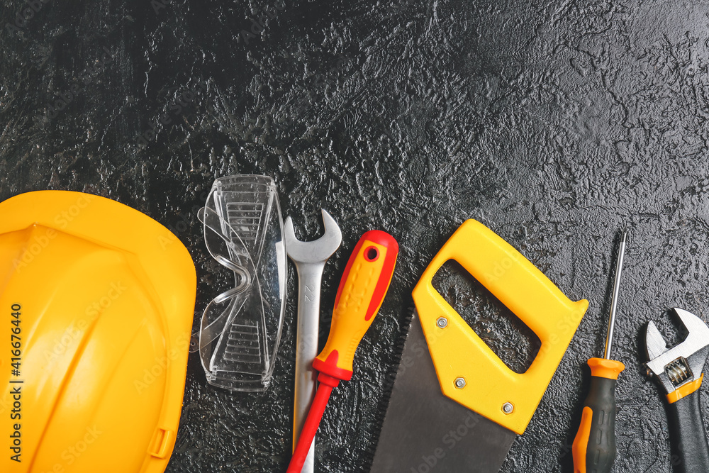 Set of construction tools on dark background