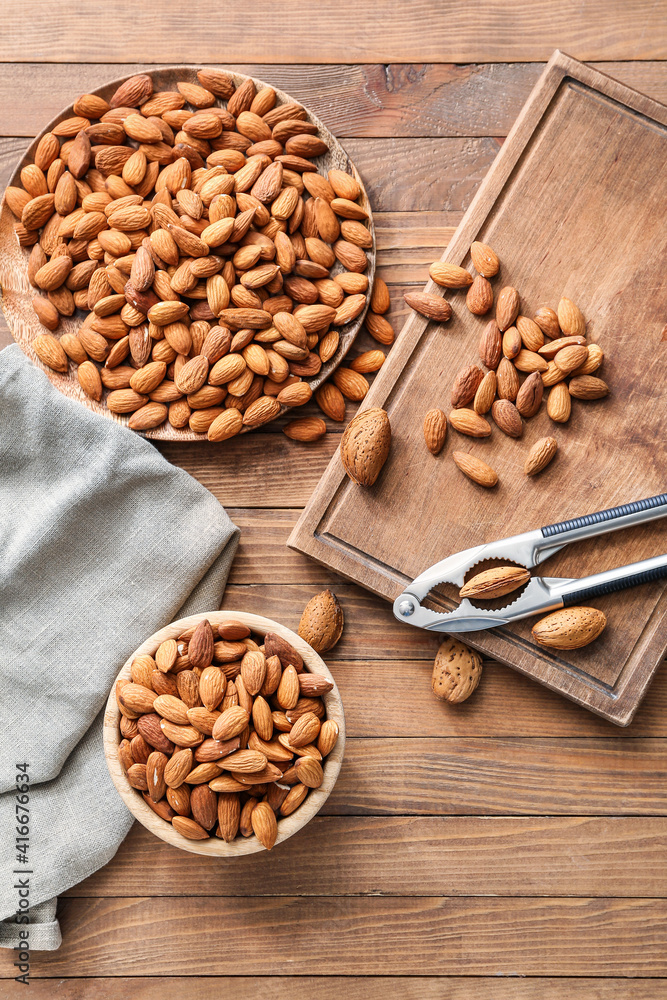 Composition with tasty almonds on wooden background