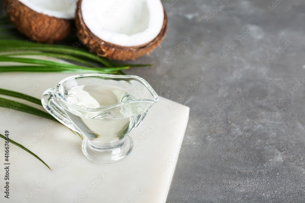 Gravy boat of coconut oil on table