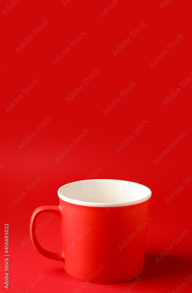 Empty cup on color background