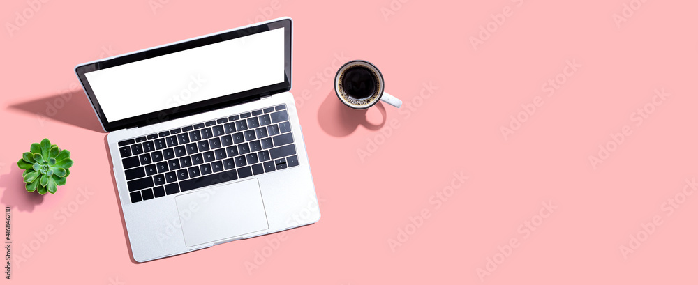 Laptop computer with a coffee cup from above